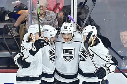 Nov 20, 2023; Tempe, Arizona, USA; Los Angeles Kings center Anze Kopitar (11) celebrates with defenseman Drew Doughty (8), center Quinton Byfield (55) and center Adrian Kempe (9) after scoring a goal against the  Arizona Coyotes in the first period at Mullett Arena. Mandatory Credit: Matt Kartozian-USA TODAY Sports