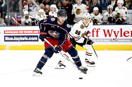 Nov 22, 2023; Columbus, Ohio, USA; Columbus Blue Jackets center Adam Fantilli (11) shoots the puck as Chicago Blackhawks center Connor Bedard (98) trails the play during the first period at Nationwide Arena. Mandatory Credit: Russell LaBounty-USA TODAY Sports