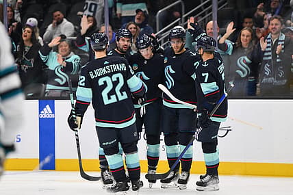 Nov 22, 2023; Seattle, Washington, USA; The Seattle Kraken celebrate after a goal scored by left wing Jared McCann (19) during the second period against the San Jose Sharks at Climate Pledge Arena. Mandatory Credit: Steven Bisig-USA TODAY Sports