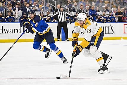 Nov 24, 2023; St. Louis, Missouri, USA;  Nashville Predators center Yakov Trenin (13) controls the puck against the St. Louis Blues during the first period at Enterprise Center. Mandatory Credit: Jeff Curry-USA TODAY Sports