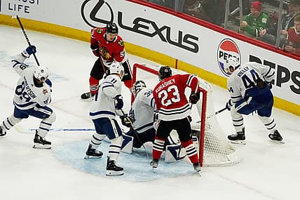 Nov 24, 2023; Chicago, Illinois, USA; Chicago Blackhawks defenseman Kevin Korchinski (55) scores the game winning goal during an overtime period against the Toronto Maple Leafs at United Center. Mandatory Credit: David Banks-USA TODAY Sports