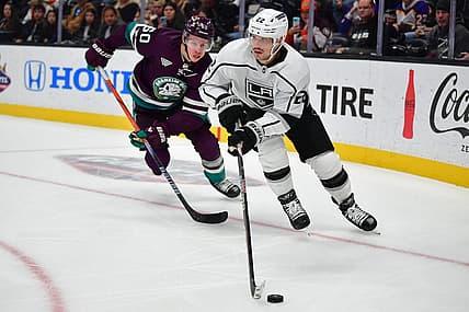 Nov 24, 2023; Anaheim, California, USA; Los Angeles Kings left wing Kevin Fiala (22) moves the puck ahead of Anaheim Ducks defenseman Jackson LaCombe (60) during the third period at Honda Center. Mandatory Credit: Gary A. Vasquez-USA TODAY Sports
