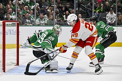 Nov 24, 2023; Dallas, Texas, USA; Dallas Stars goaltender Jake Oettinger (29) turns aside a shot by Calgary Flames center Dillon Dube (29) during the first period at the American Airlines Center. Mandatory Credit: Jerome Miron-USA TODAY Sports