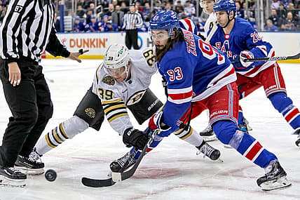 Nov 25, 2023; New York, New York, USA; Boston Bruins center Morgan Geekie (39) and New York Rangers center Mika Zibanejad (93) battle for the puck after a face-off during the first period at Madison Square Garden. Mandatory Credit: Danny Wild-USA TODAY Sports