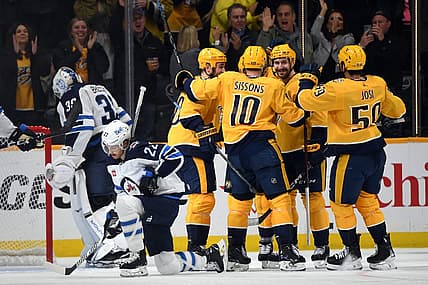 Nov 26, 2023; Nashville, Tennessee, USA; Nashville Predators players celebrate a goal by left wing Gustav Nyquist (14) during the second period against the Winnipeg Jets at Bridgestone Arena. Mandatory Credit: Christopher Hanewinckel-USA TODAY Sports