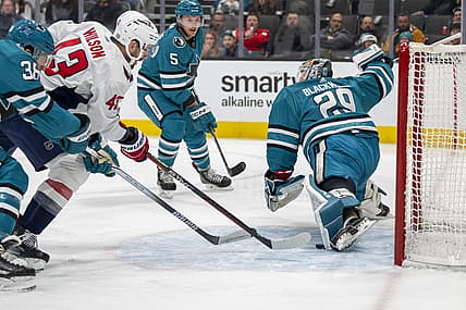 Nov 27, 2023; San Jose, California, USA; San Jose Sharks goaltender Mackenzie Blackwood (29) makes a leg save against Washington Capitals right wing Tom Wilson (43) during the first period at SAP Center at San Jose. Mandatory Credit: Neville E. Guard-USA TODAY Sports