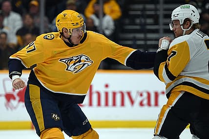 Nov 28, 2023; Nashville, Tennessee, USA; Nashville Predators right wing Michael McCarron (47) and Pittsburgh Penguins defense John Ludvig (7) exchange hits in a fight during the second period at Bridgestone Arena. Mandatory Credit: Christopher Hanewinckel-USA TODAY Sports