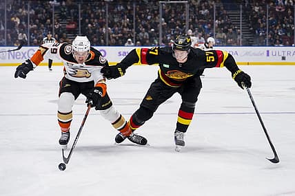 Nov 28, 2023; Vancouver, British Columbia, CAN; Vancouver Canucks defenseman Tyler Myers (57) battles with Anaheim Ducks forward Sam Carrick (39) in the first period at Rogers Arena. Mandatory Credit: Bob Frid-USA TODAY Sports