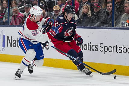 Nov 29, 2023; Columbus, Ohio, USA;  Columbus Blue Jackets center Alexandre Texier (42) skates with the puck against Montreal Canadiens defenseman Justin Barron (52) in the second period at Nationwide Arena. Mandatory Credit: Aaron Doster-USA TODAY Sports