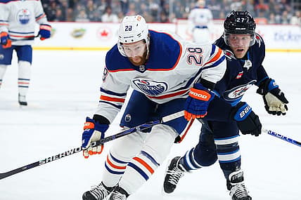 Nov 30, 2023; Winnipeg, Manitoba, CAN; Edmonton Oilers forward Connor Brown (28) jostles for position with Winnipeg Jets forward Nikolaj Ehlers (27) during the first period at Canada Life Centre. Mandatory Credit: Terrence Lee-USA TODAY Sports