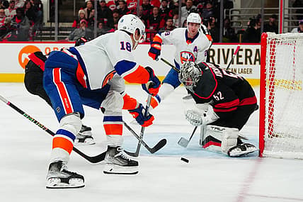 Nov 30, 2023; Raleigh, North Carolina, USA; Carolina Hurricanes goaltender Pyotr Kochetkov (52) stops the scoring attempt by New York Islanders left wing Pierre Engvall (18) during the second period at PNC Arena. Mandatory Credit: James Guillory-USA TODAY Sports