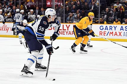 Nov 26, 2023; Nashville, Tennessee, USA; Winnipeg Jets center Mark Scheifele (55) shoots the puck during the second period against the Nashville Predators at Bridgestone Arena. Mandatory Credit: Christopher Hanewinckel-USA TODAY Sports