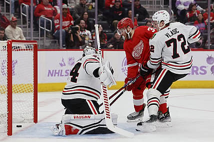Nov 30, 2023; Detroit, Michigan, USA; Detroit Red Wings left wing J.T. Compher (37) scores a goal on Chicago Blackhawks goaltender Petr Mrazek (34) in the second period at Little Caesars Arena. Mandatory Credit: Rick Osentoski-USA TODAY Sports
