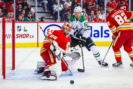 Nov 30, 2023; Calgary, Alberta, CAN; Calgary Flames goaltender Jacob Markstrom (25) makes a save against Dallas Stars right wing Evgenii Dadonov (63) during the first period at Scotiabank Saddledome. Mandatory Credit: Sergei Belski-USA TODAY Sports