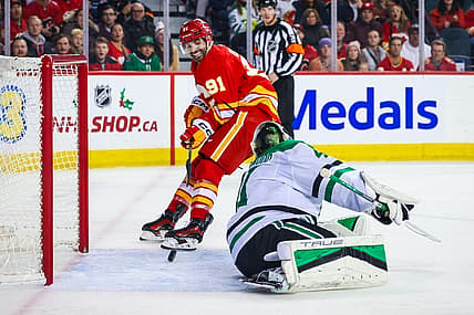 Nov 30, 2023; Calgary, Alberta, CAN; Calgary Flames center Nazem Kadri (91) scores a goal against Dallas Stars goaltender Scott Wedgewood (41) during the overtime period at Scotiabank Saddledome. Mandatory Credit: Sergei Belski-USA TODAY Sports
