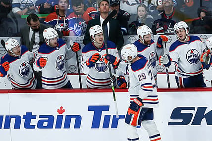 Nov 30, 2023; Winnipeg, Manitoba, CAN; Edmonton Oilers forward Leon Draisaitl (29) is congratulated by his team mates on his goal against the Winnipeg Jets during the third period at Canada Life Centre. Mandatory Credit: Terrence Lee-USA TODAY Sports