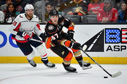 Nov 30, 2023; Anaheim, California, USA; Anaheim Ducks defenseman Tristan Luneau (67) moves the puck ahead of Washington Capitals right wing Anthony Mantha (39) during the third period at Honda Center. Mandatory Credit: Gary A. Vasquez-USA TODAY Sports