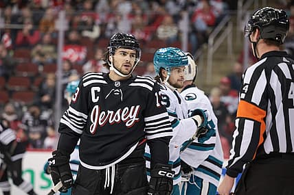 Dec 1, 2023; Newark, New Jersey, USA; New Jersey Devils center Nico Hischier (13) talks with referee Wes McCauley (4) during the first period against the San Jose Sharks at Prudential Center. Mandatory Credit: Vincent Carchietta-USA TODAY Sports