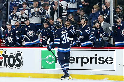 Dec 2, 2023; Winnipeg, Manitoba, CAN;  Winnipeg Jets forward Morgan Barron (36) is congratulated by his team mates on his goal against the Chicago Blackhawks during the second period at Canada Life Centre. Mandatory Credit: Terrence Lee-USA TODAY Sports