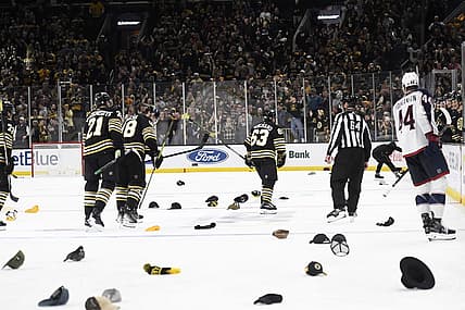 Dec 3, 2023; Boston, Massachusetts, USA; Boston Bruins left wing Brad Marchand (63) celebrates his third goal as fans throw their hats on the ice for his    hat trick    during the third period against the Columbus Blue Jackets at TD Garden. Mandatory Credit: Bob DeChiara-USA TODAY Sports