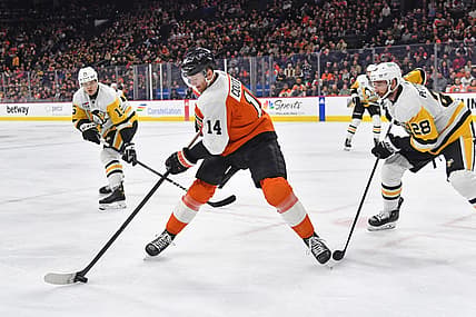 Dec 4, 2023; Philadelphia, Pennsylvania, USA; Philadelphia Flyers center Sean Couturier (14) controls the puck against Pittsburgh Penguins left wing Joona Koppanen (15) and defenseman Marcus Pettersson (28) during the first period at Wells Fargo Center. Mandatory Credit: Eric Hartline-USA TODAY Sports