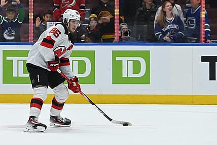 Dec 5, 2023; Vancouver, British Columbia, CAN; New Jersey Devils center Jack Hughes (86) controls the puck during the pregame warmup against the Vancouver Canucks at Rogers Arena. Mandatory Credit: Simon Fearn-USA TODAY Sports