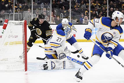 Dec 7, 2023; Boston, Massachusetts, USA; Buffalo Sabres goaltender Devon Levi (27) makes a save in front of Boston Bruins center Trent Frederic (11) and defenseman Henri Jokiharju (10) during the first period at TD Garden. Mandatory Credit: Bob DeChiara-USA TODAY Sports
