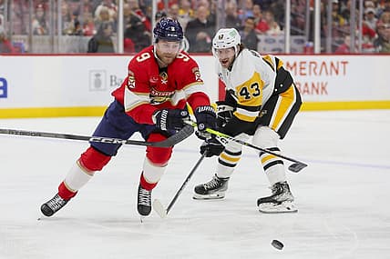 Dec 8, 2023; Sunrise, Florida, USA; Florida Panthers center Sam Bennett (9) protects the puck from Pittsburgh Penguins center Jansen Harkins (43) during the second period at Amerant Bank Arena. Mandatory Credit: Sam Navarro-USA TODAY Sports