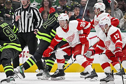 Dec 11, 2023; Dallas, Texas, USA; Dallas Stars center Tyler Seguin (91) and Detroit Red Wings right wing Christian Fischer (36) battle for control of the puck during the first period at the American Airlines Center. Mandatory Credit: Jerome Miron-USA TODAY Sports