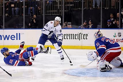 Dec 12, 2023; New York, New York, USA; Toronto Maple Leafs center John Tavares (91) skates with the puck against New York Rangers defenseman Erik Gustafsson (56) and goaltender Igor Shesterkin (31) during the third period at Madison Square Garden. Mandatory Credit: Brad Penner-USA TODAY Sports