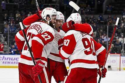 Dec 12, 2023; St. Louis, Missouri, USA;  Detroit Red Wings center Michael Rasmussen (27) is congratulated by defenseman Moritz Seider (53) and center Joe Veleno (90) after scoring against the St. Louis Blues during the third period at Enterprise Center. Mandatory Credit: Jeff Curry-USA TODAY Sports
