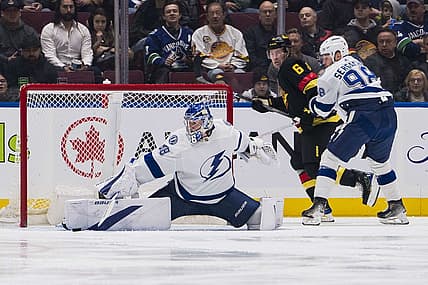 Dec 12, 2023; Vancouver, British Columbia, CAN; Vancouver Canucks forward Brock Boeser (6) and Tampa Bay Lightning defenseman Mikhail Sergachev (98) watch as goalie Andrei Vasilevskiy (88) makes a save in the first period at Rogers Arena. Mandatory Credit: Bob Frid-USA TODAY Sports