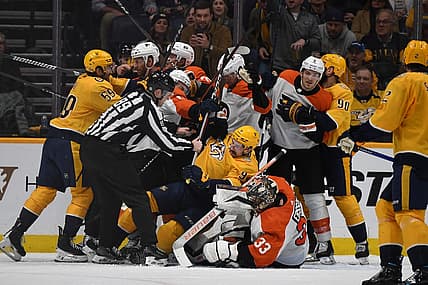 Dec 12, 2023; Nashville, Tennessee, USA; Nashville Predators and Philadelphia Flyers players have to be separated after a save by Philadelphia Flyers goaltender Samuel Ersson (33) during the second period at Bridgestone Arena. Mandatory Credit: Christopher Hanewinckel-USA TODAY Sports