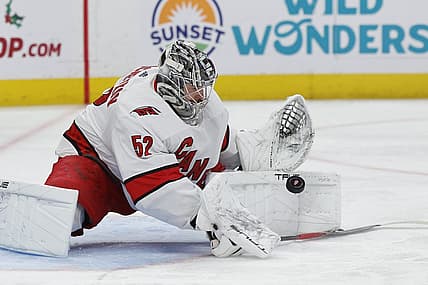 Dec 14, 2023; Detroit, Michigan, USA; Carolina Hurricanes goaltender Pyotr Kochetkov (52) makes a save in the second period against the Detroit Red Wings at Little Caesars Arena. Mandatory Credit: Rick Osentoski-USA TODAY Sports