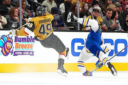Dec 15, 2023; Las Vegas, Nevada, USA; Vegas Golden Knights center Ivan Barbashev (49) checks Buffalo Sabres center Dylan Cozens (24) during the second period at T-Mobile Arena. Mandatory Credit: Stephen R. Sylvanie-USA TODAY Sports