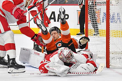 Dec 16, 2023; Philadelphia, Pennsylvania, USA; Philadelphia Flyers left wing Joel Farabee (86) lands on top of Detroit Red Wings goaltender Alex Lyon (34) during the first period at Wells Fargo Center. Mandatory Credit: Eric Hartline-USA TODAY Sports