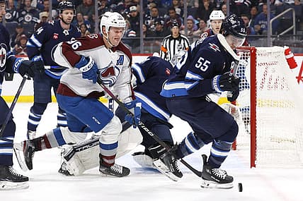 Dec 16, 2023; Winnipeg, Manitoba, CAN; Colorado Avalanche right wing Mikko Rantanen (96) and Winnipeg Jets center Mark Scheifele (55) chase after the puck in the first period at Canada Life Centre. Mandatory Credit: James Carey Lauder-USA TODAY Sports