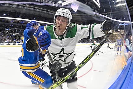 Dec 16, 2023; St. Louis, Missouri, USA;  Dallas Stars center Ty Dellandrea (10) and St. Louis Blues defenseman Tyler Tucker (75) battle for the puck during the first period at Enterprise Center. Mandatory Credit: Jeff Curry-USA TODAY Sports