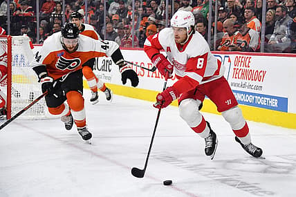 Dec 16, 2023; Philadelphia, Pennsylvania, USA; Detroit Red Wings defenseman Ben Chiarot (8) skates with the puck against Philadelphia Flyers left wing Nicolas Deslauriers (44) during the third period at Wells Fargo Center. Mandatory Credit: Eric Hartline-USA TODAY Sports