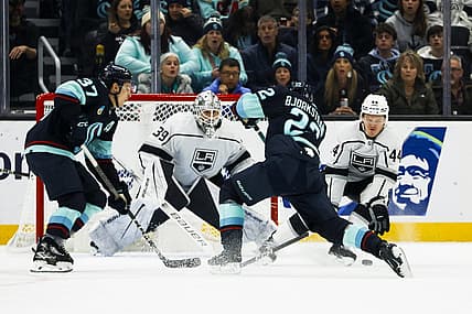 Dec 16, 2023; Seattle, Washington, USA; Los Angeles Kings defenseman Mikey Anderson (44) blocks a shot by Seattle Kraken right wing Oliver Bjorkstrand (22) during the first period at Climate Pledge Arena. Seattle Kraken center Yanni Gourde (37) and Los Angeles Kings goaltender Cam Talbot (39) follow the play at left. Mandatory Credit: Joe Nicholson-USA TODAY Sports