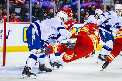 Dec 16, 2023; Calgary, Alberta, CAN; Tampa Bay Lightning defenseman Erik Cernak (81) and Calgary Flames center Yegor Sharangovich (17) battle for the puck during the second period at Scotiabank Saddledome. Mandatory Credit: Sergei Belski-USA TODAY Sports