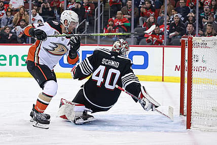 Dec 17, 2023; Newark, New Jersey, USA; Anaheim Ducks center Adam Henrique (14) scores a goal past New Jersey Devils goaltender Akira Schmid (40) during the second period at Prudential Center. Mandatory Credit: Vincent Carchietta-USA TODAY Sports