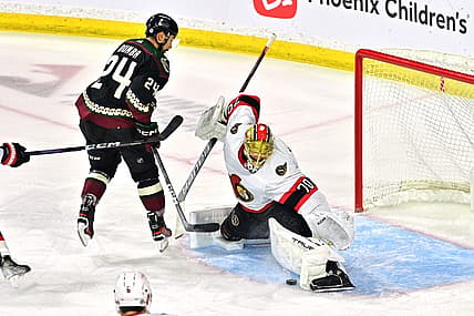 Dec 19, 2023; Tempe, Arizona, USA; Ottawa Senators goaltender Joonas Korpisalo (70) makes a save on Arizona Coyotes defenseman Matt Dumba (24) in the first period at Mullett Arena. Mandatory Credit: Matt Kartozian-USA TODAY Sports
