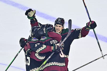 Dec 19, 2023; Tempe, Arizona, USA; Arizona Coyotes defenseman Michael Kesselring (5) celebrates with center Jack McBain (22) and defenseman Travis Dermott (33) after scoring a goal in the third period against the Ottawa Senators at Mullett Arena. Mandatory Credit: Matt Kartozian-USA TODAY Sports