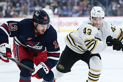 Dec 22, 2023; Winnipeg, Manitoba, CAN;  Winnipeg Jets forward Gabriel Vilardi (13) and Boston Bruins forward Danton Heinen (43) skate after the puck during the first period at Canada Life Centre. Mandatory Credit: Terrence Lee-USA TODAY Sports