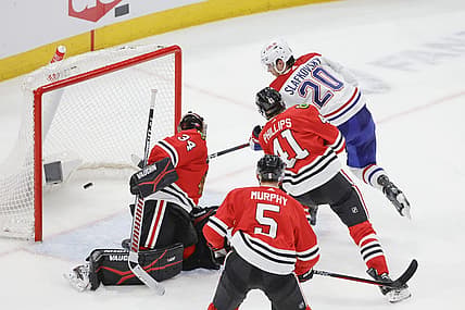 Dec 22, 2023; Chicago, Illinois, USA; Montreal Canadiens left wing Juraj Slafkovsky (20) shoots and scores against Chicago Blackhawks goaltender Petr Mrazek (34) during the second period at United Center. Mandatory Credit: Kamil Krzaczynski-USA TODAY Sports