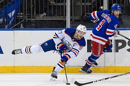 Dec 22, 2023; New York, New York, USA;  Edmonton Oilers center Connor McDavid (97) passes the puck against the New York Rangers during the third period at Madison Square Garden. Mandatory Credit: Dennis Schneidler-USA TODAY Sports