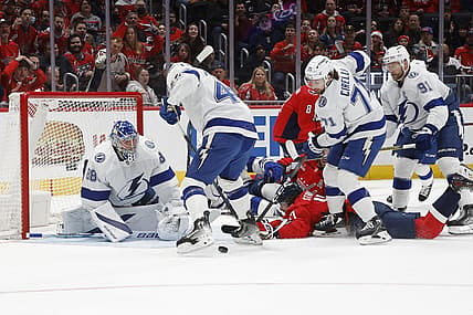 Dec 23, 2023; Washington, District of Columbia, USA; Washington Capitals center Dylan Strome (17) is checked from behind by Tampa Bay Lightning center Steven Stamkos (91) while reaching for the puck in front of Lightning goaltender Andrei Vasilevskiy (88) in the first period at Capital One Arena. Mandatory Credit: Geoff Burke-USA TODAY Sports