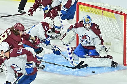 Dec 27, 2023; Tempe, Arizona, USA; Colorado Avalanche goaltender Alexandar Georgiev (40) and center Andrew Cogliano (11) defend as Arizona Coyotes center Liam O'Brien (38) attacks in the first period at Mullett Arena. Mandatory Credit: Matt Kartozian-USA TODAY Sports