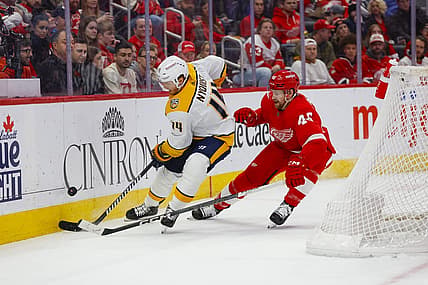 Dec 29, 2023; Detroit, Michigan, USA; Nashville Predators center Gustav Nyquist (14) handles the puck under pressure from Detroit Red Wings defenseman Jeff Petry (46) during the first of the game between the Nashville Predators and the Detroit Red Wings at Little Caesars Arena. Mandatory Credit: Brian Bradshaw Sevald-USA TODAY Sports